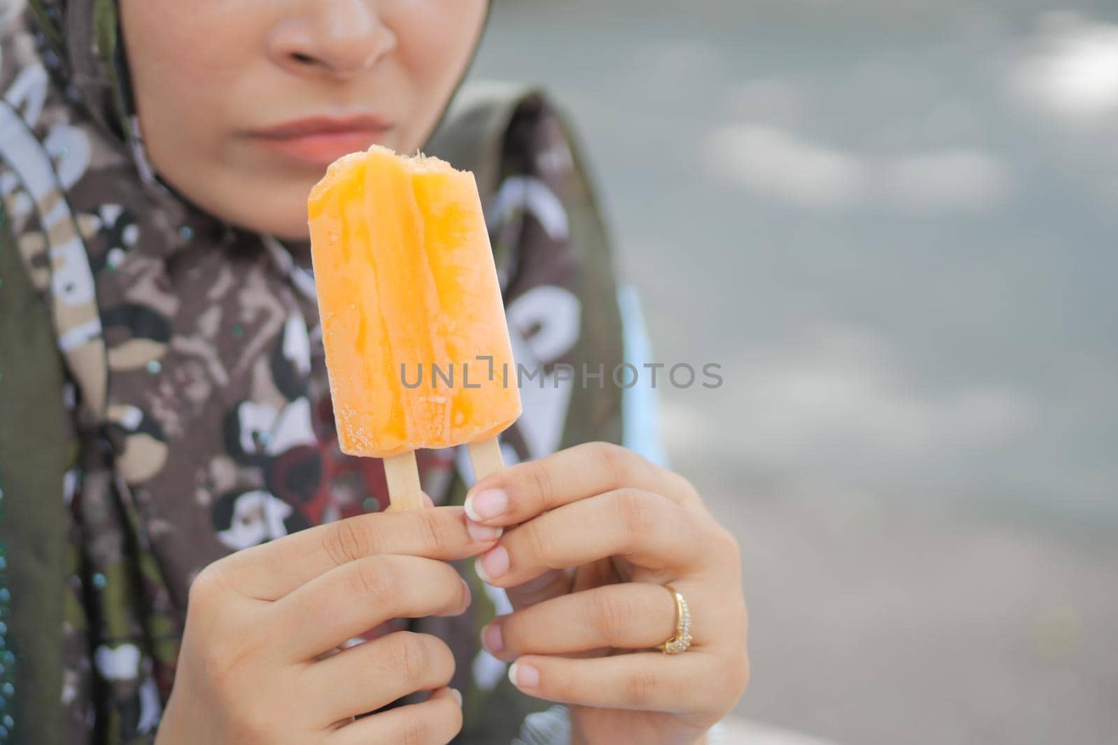 young women eating chocolate flavor ice cream .