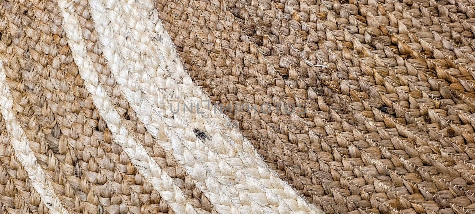 handmade straw rug with white details by sarsa