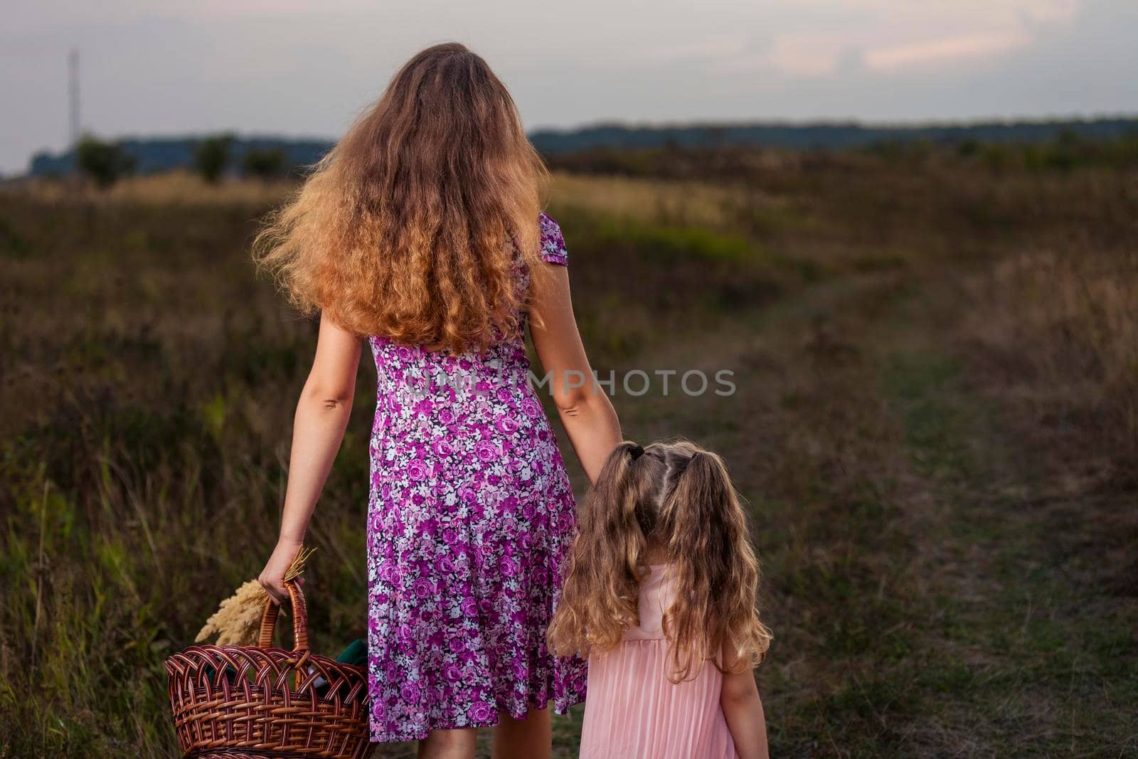 mother and daughter walking in nature by zokov