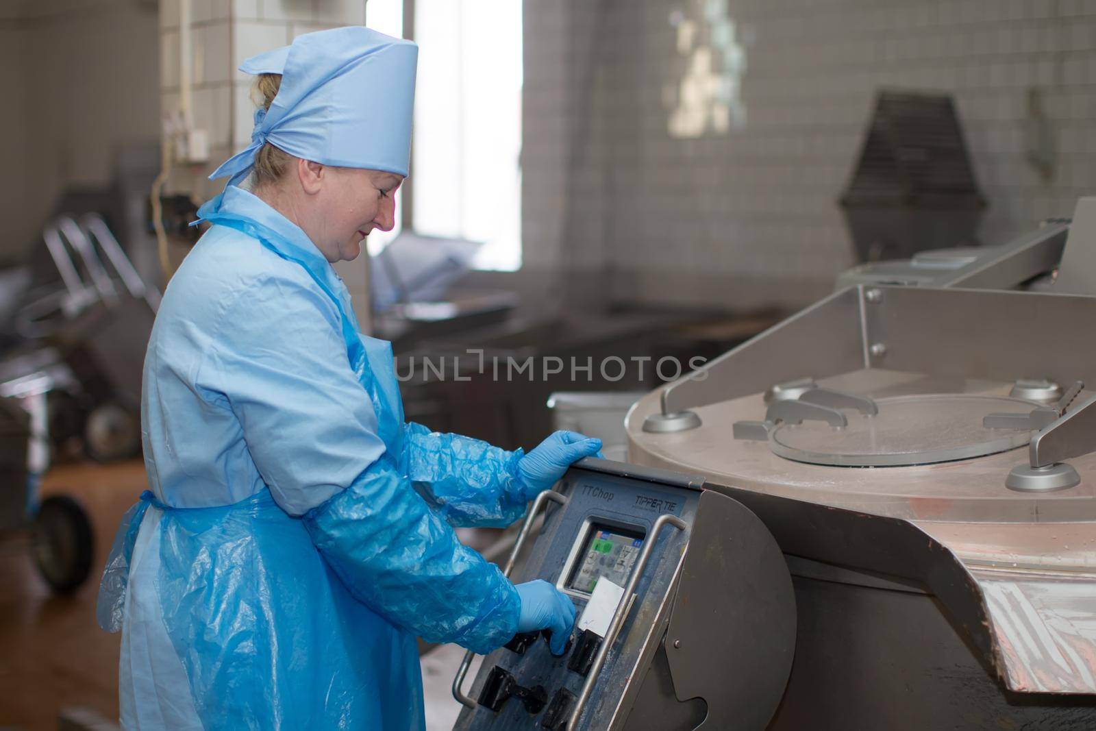 Belarus, the city of Gomel, on April 26, 2018. The first meat factory. The worker of a meat factory for the device for preparation of forcemeat