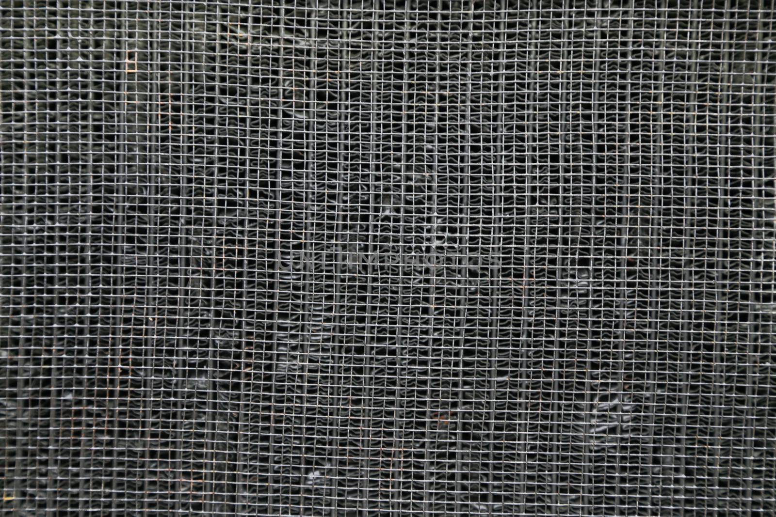 Top view of the surface of a metal radiator. Abstract background of metal wire fabric.