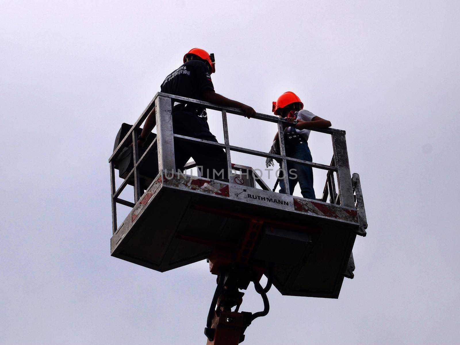 Varna, Bulgaria -September, 13, 2020: firefighter lifts teenage girl on telescopic boom during training drills