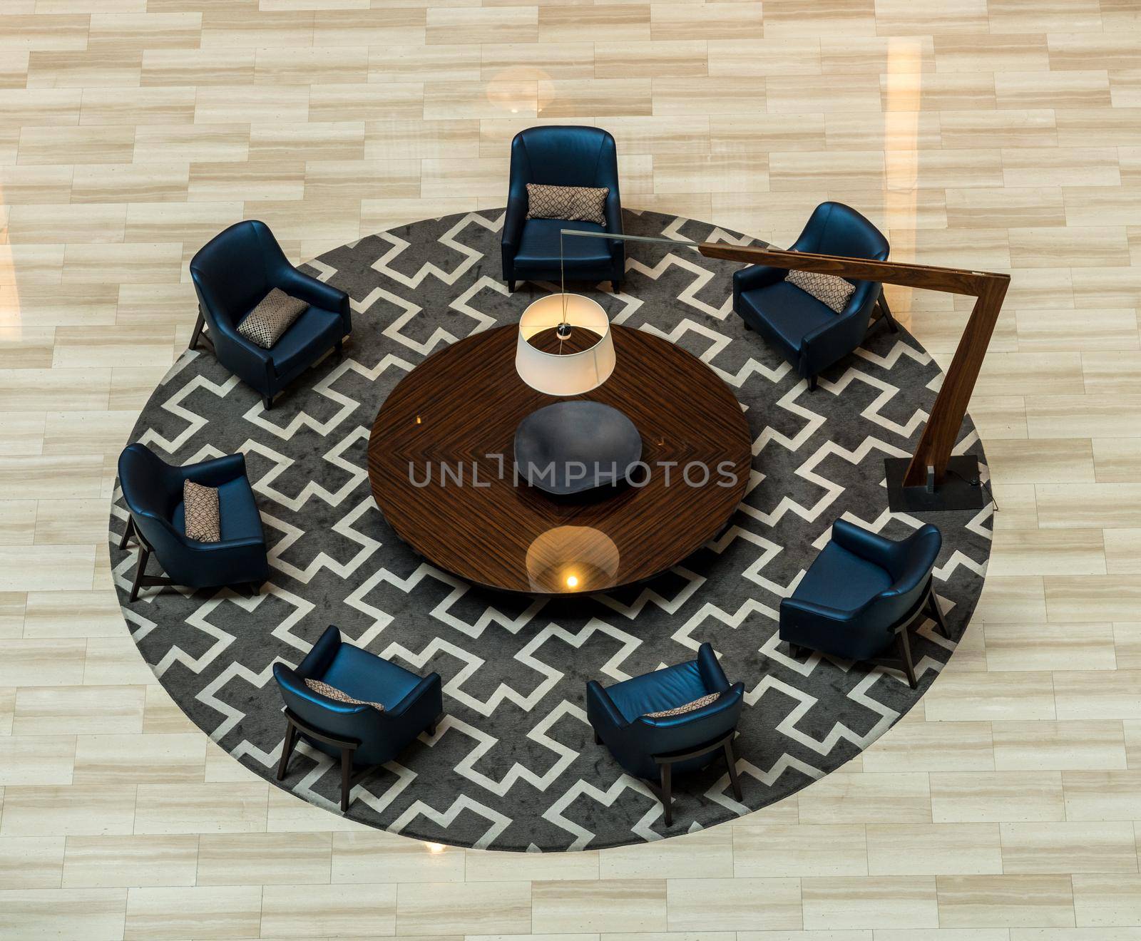 Aerial view above a hotel lobby with round table and chairs with no people due to coronavirus restrictions