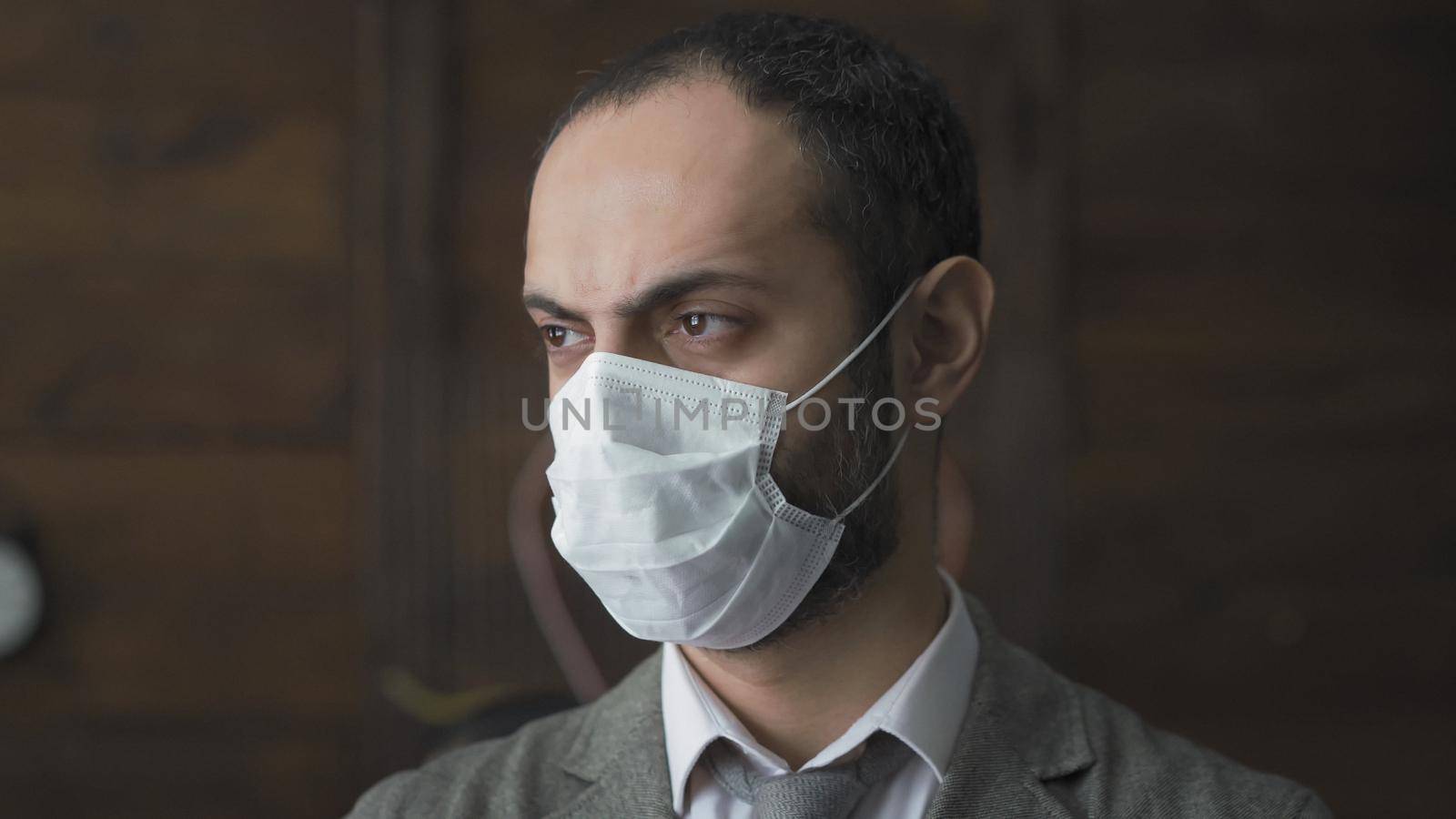 Businessman In Mask Is Sad In Isolation Durind Quarantine by LipikStockMedia