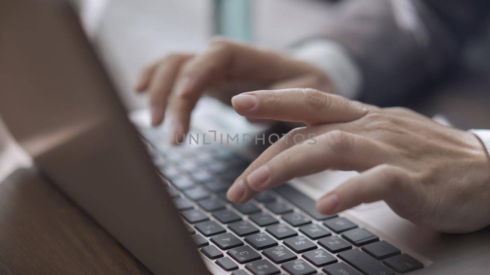 Business Woman In Suit Works With Laptop Sitting At Office Desk With Sanitizer On It, Close Up Of Female Hands Working On Laptop Keyboard, Quarantine Concept