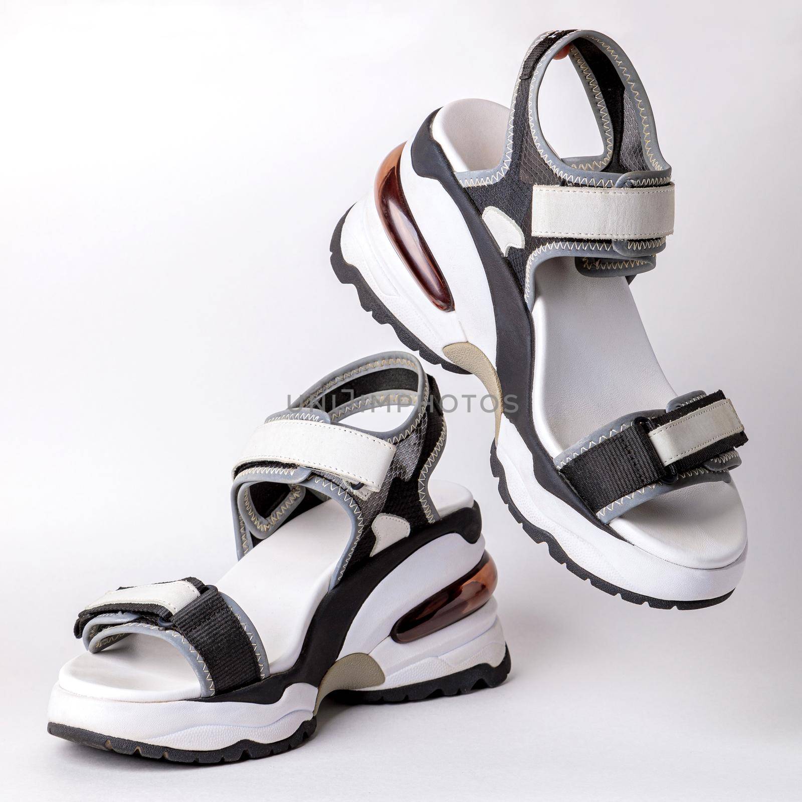 Women's, fashionable, sports sandals on a white background. New youth shoes for girls. Foreground.