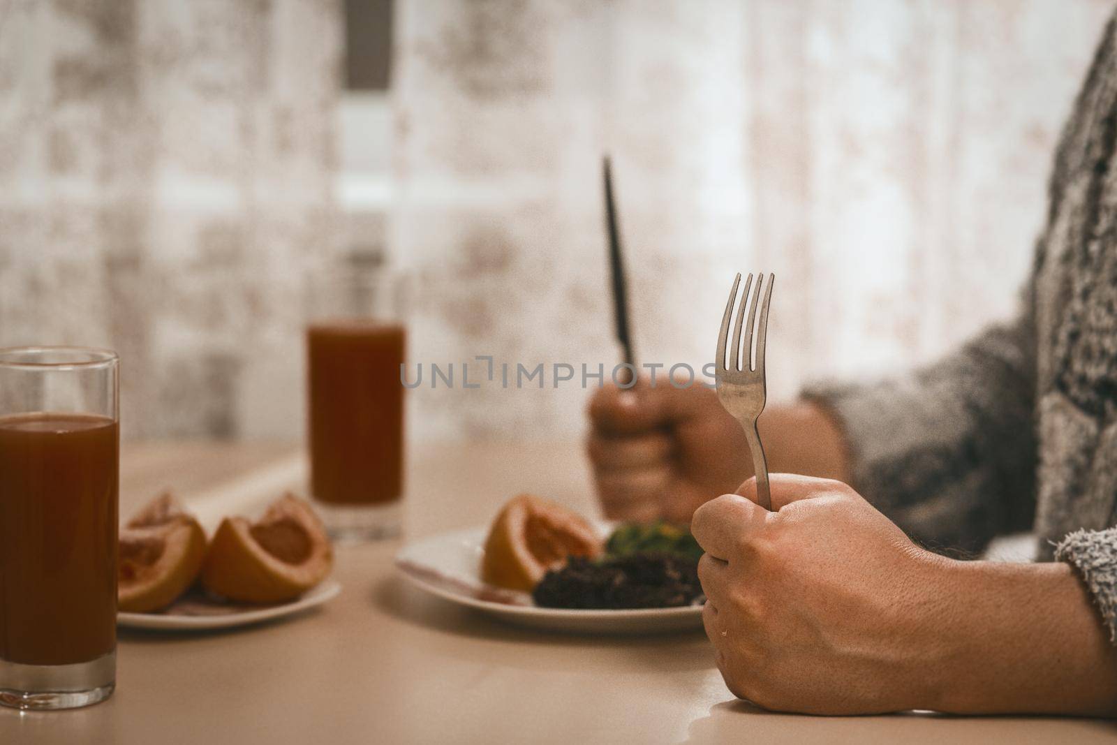 Close Up Of Male Hands Setting To Eat Healthy Food by LipikStockMedia