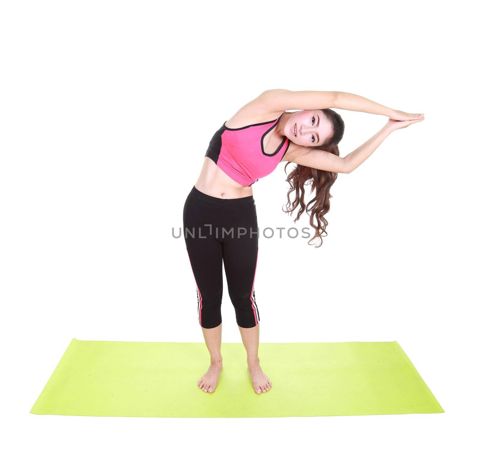 Young woman doing yoga exercise with yoga mat isolated on white background