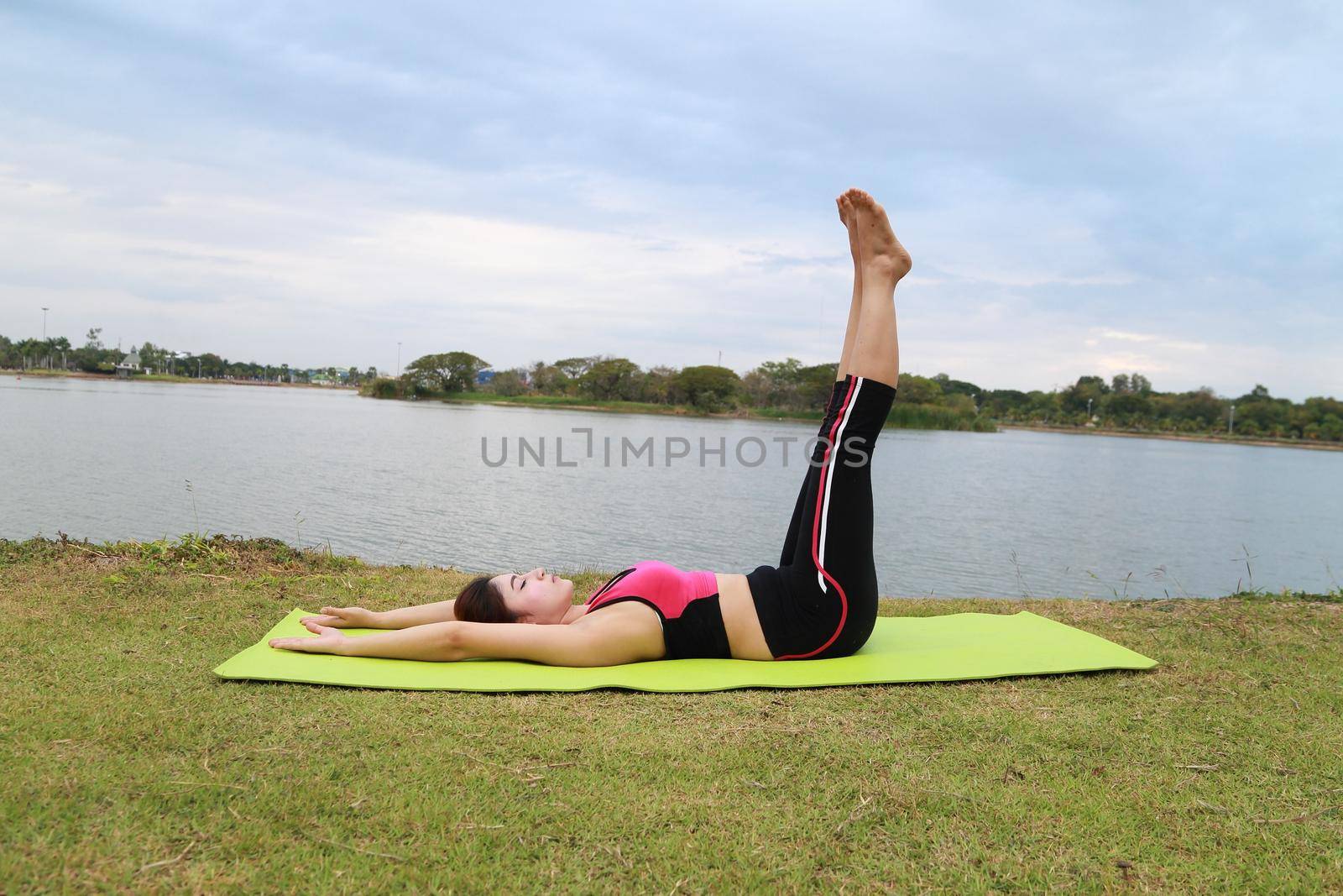 Young woman doing yoga exercise in the park