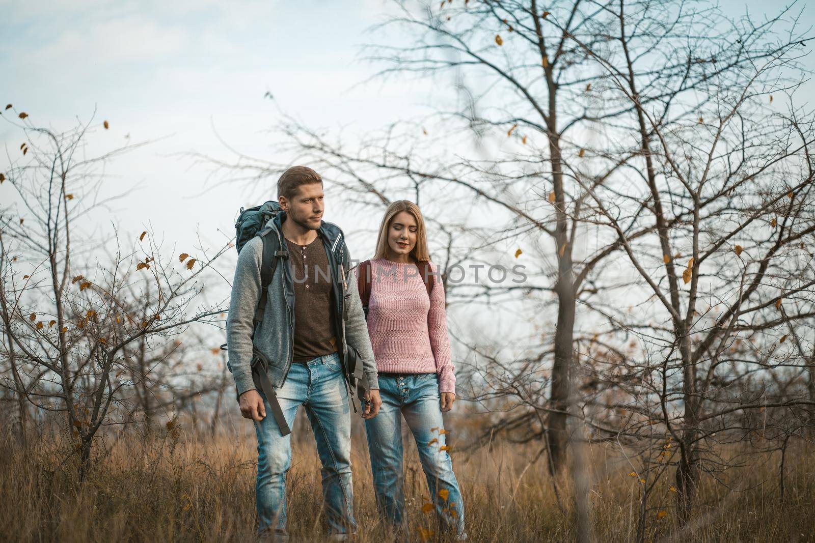 Young Man And Woman hiking In Nature together by LipikStockMedia