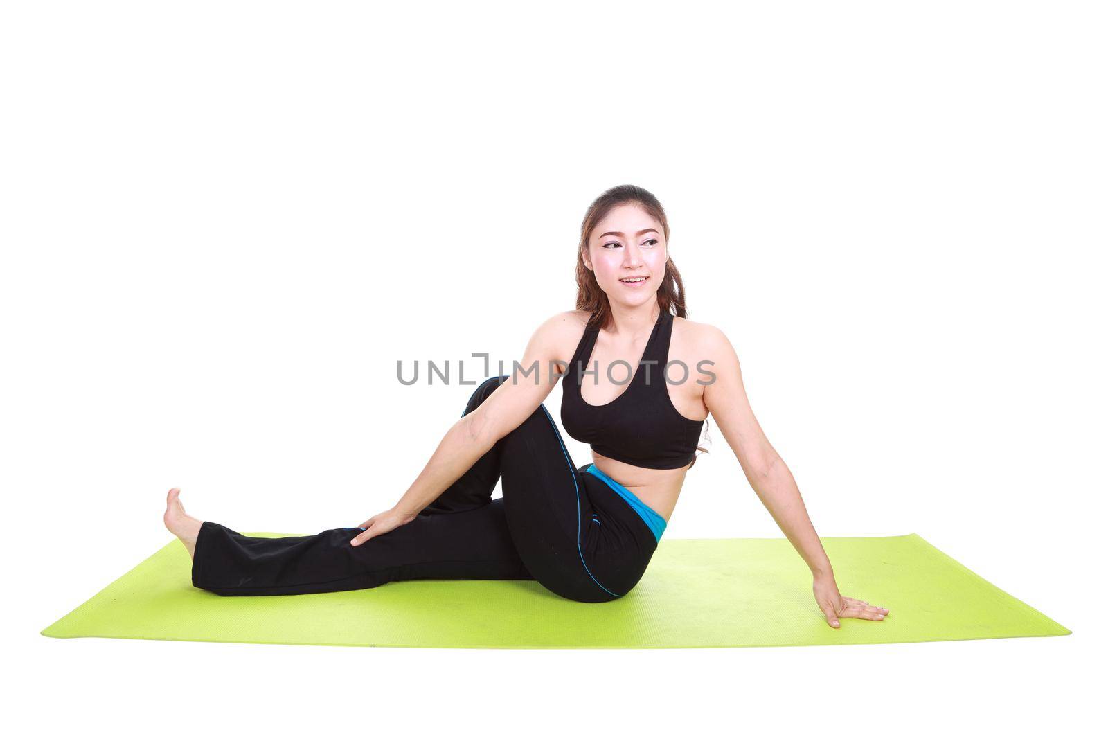 Young woman doing yoga exercise with yoga mat by geargodz