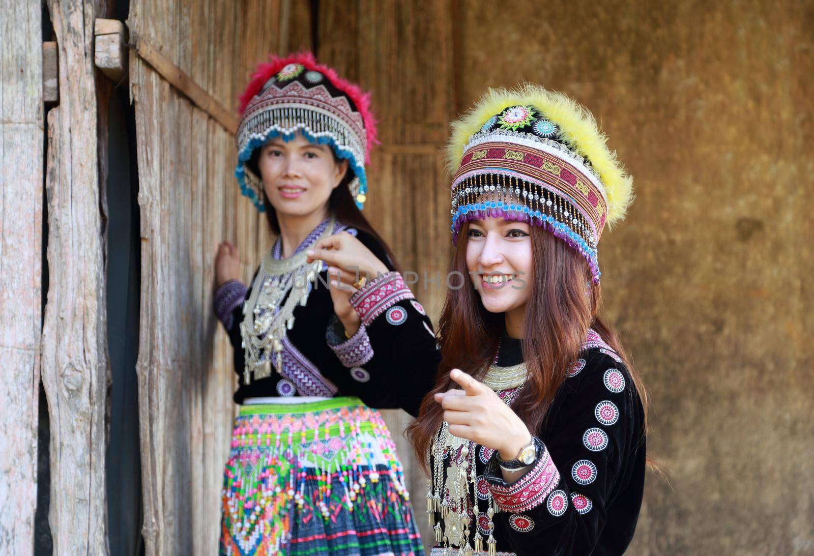 Traditionally dressed Mhong hill tribe woman in the wooden cottage