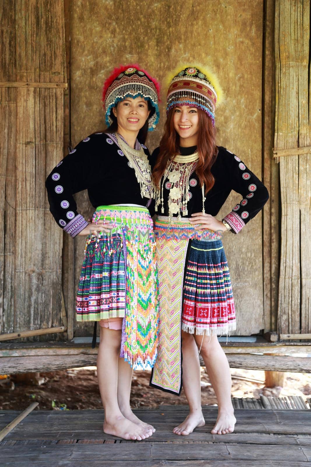 Traditionally dressed Mhong hill tribe woman in the wooden cottage