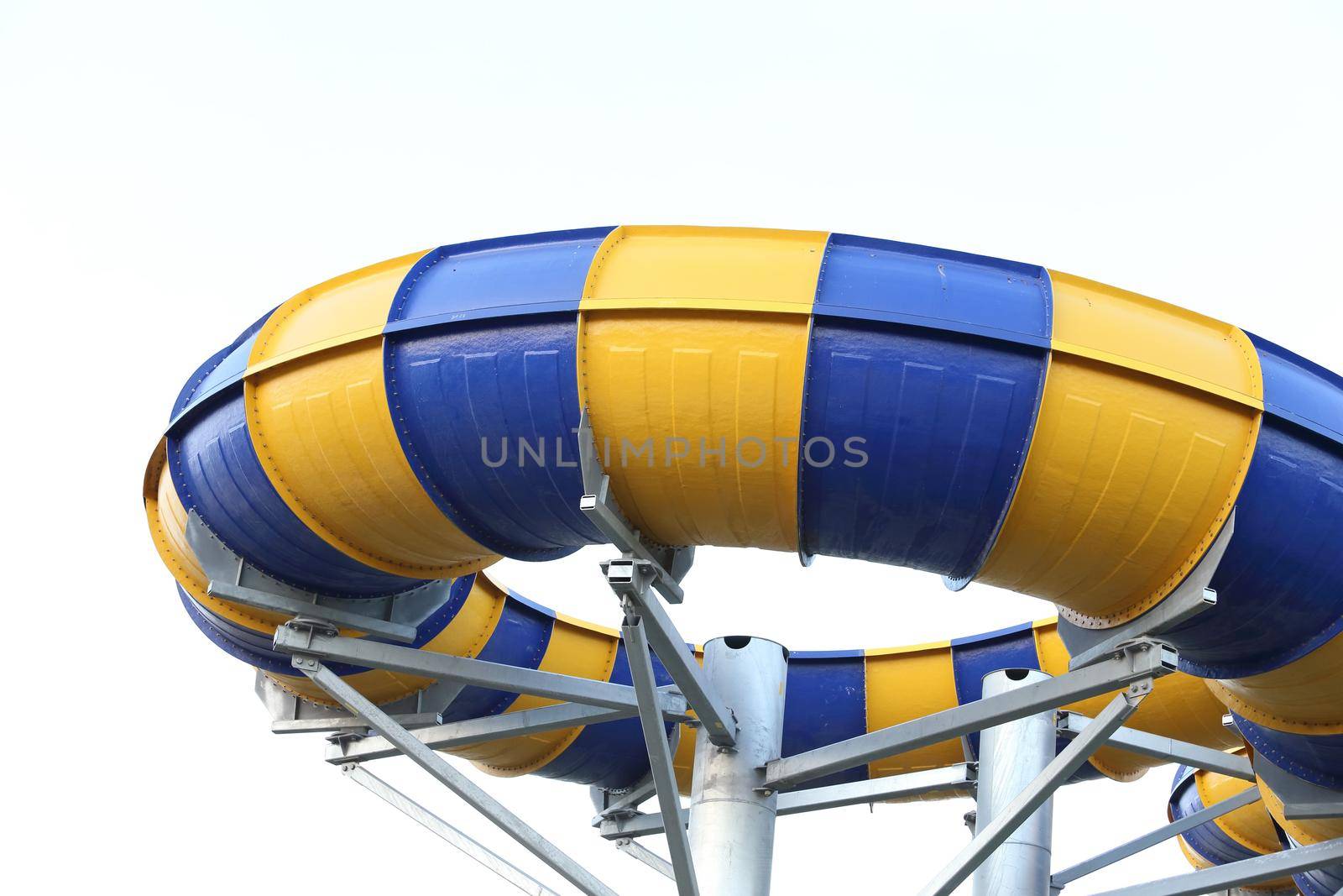 Slider in swimming pool with sky background