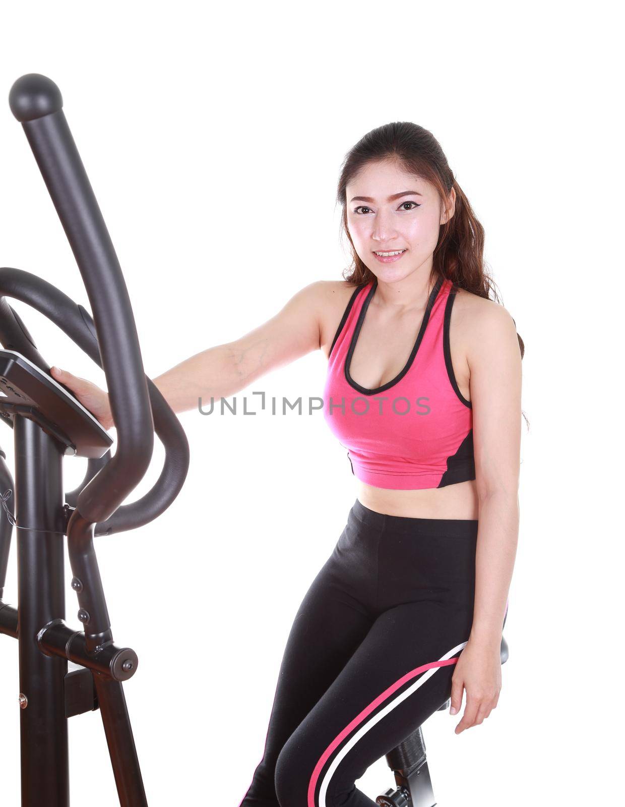 young woman doing exercises with exercise machine, on white background