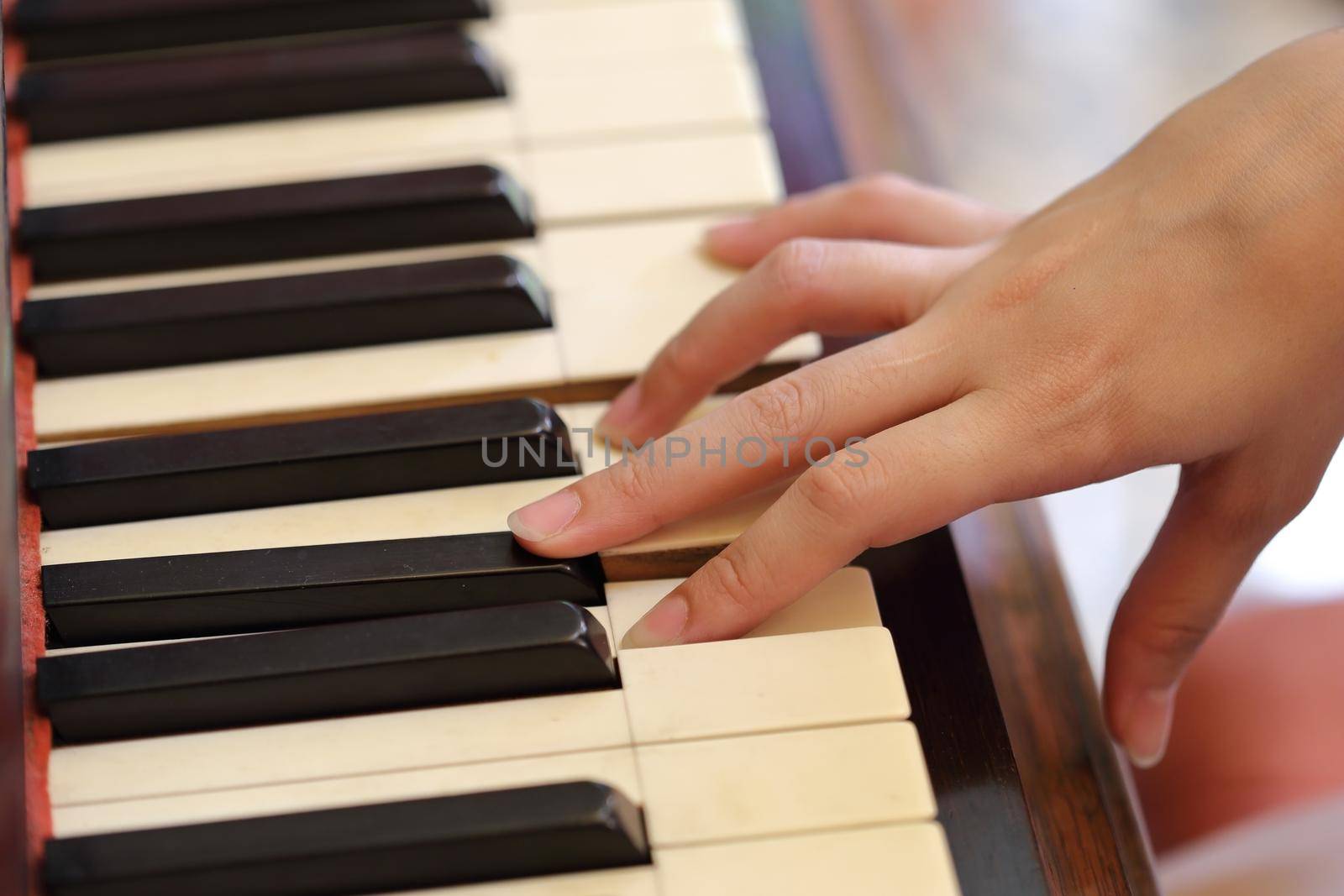 hands playing the classic wood  piano by geargodz