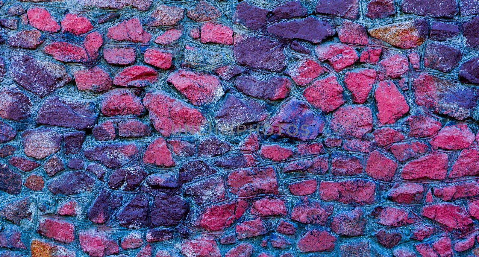 Abstract background of blue and red stones. A wall of blue and red stones.