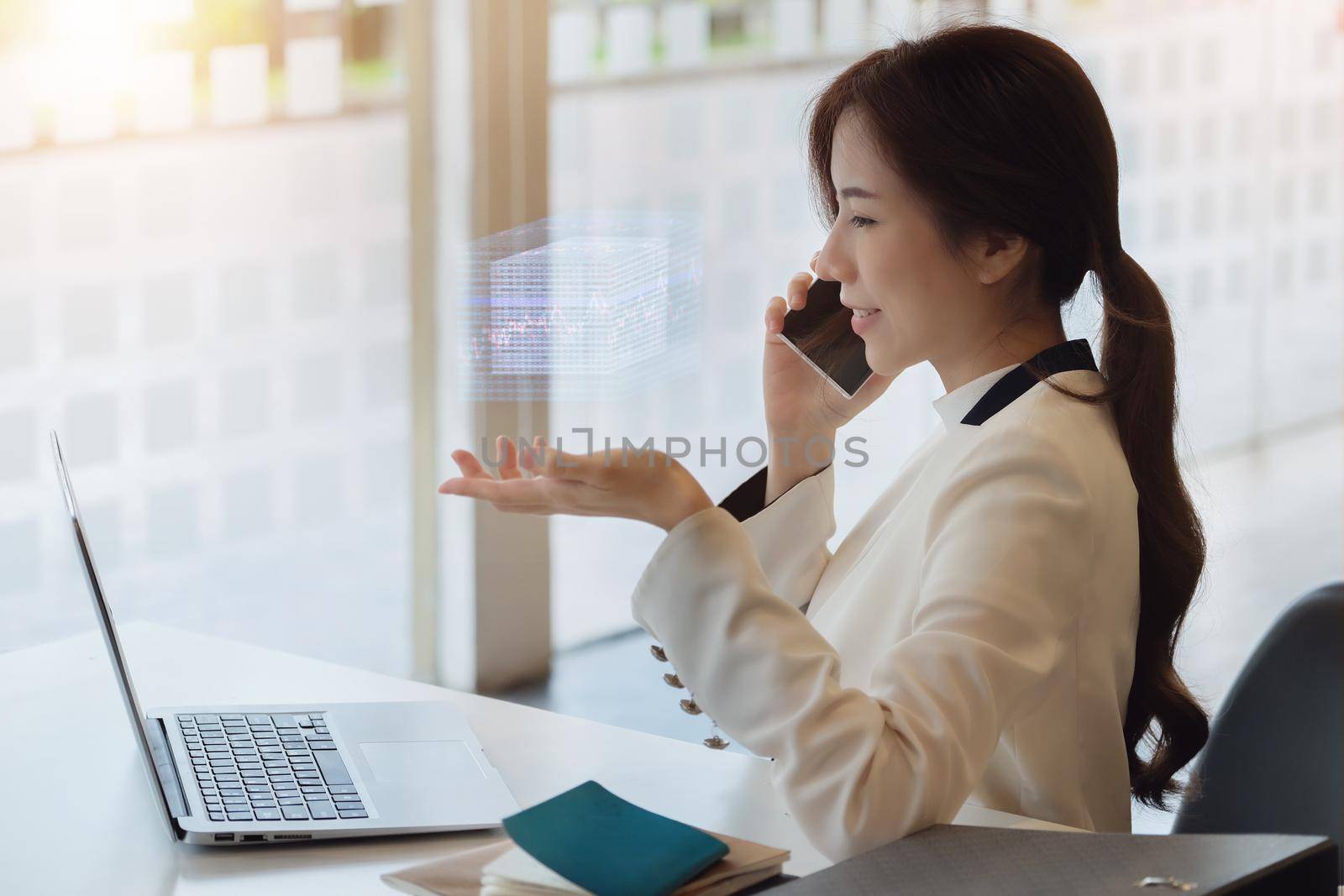 Business woman using computer to trade charts to find buy and sell points for her port. by Manastrong