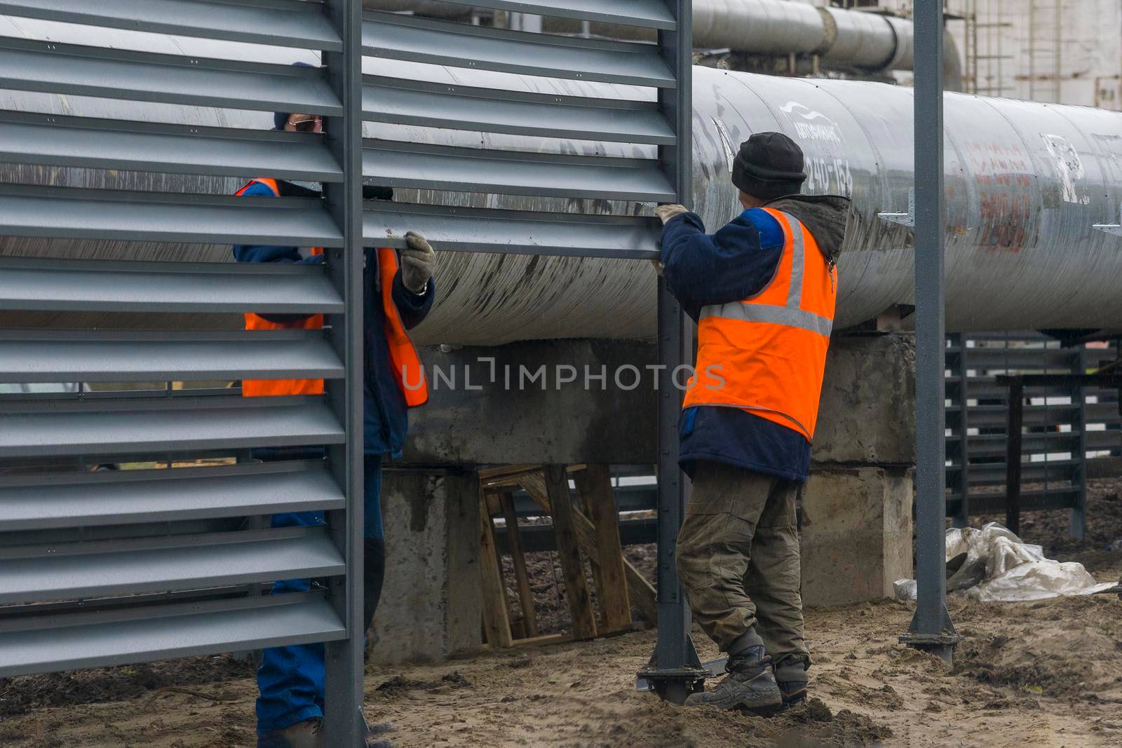 Workers build a fence, Bashkortostan, Russia - 19 June, 2022. by Essffes