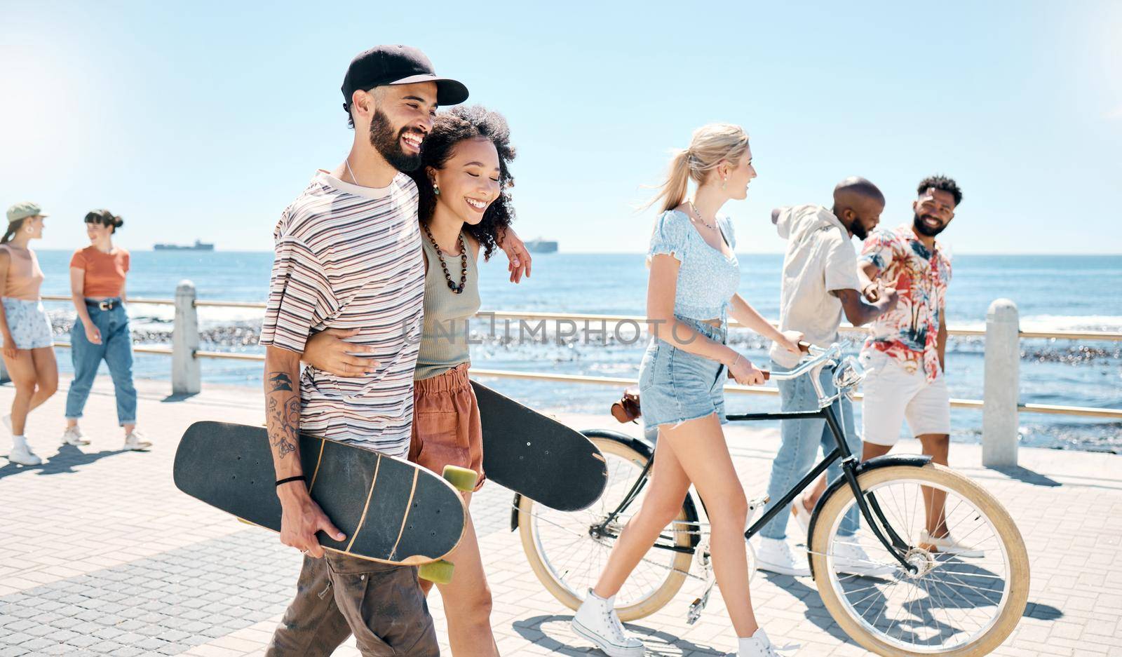 a young couple waking together during a day outdoors with their friends.