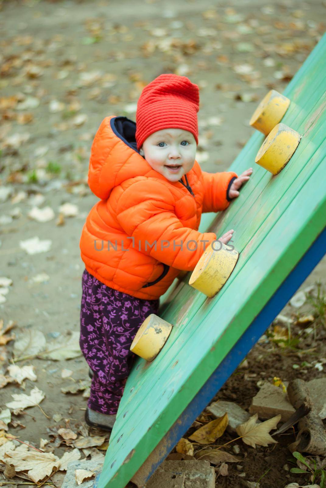 the child climbs the steps on the playground. High quality photo