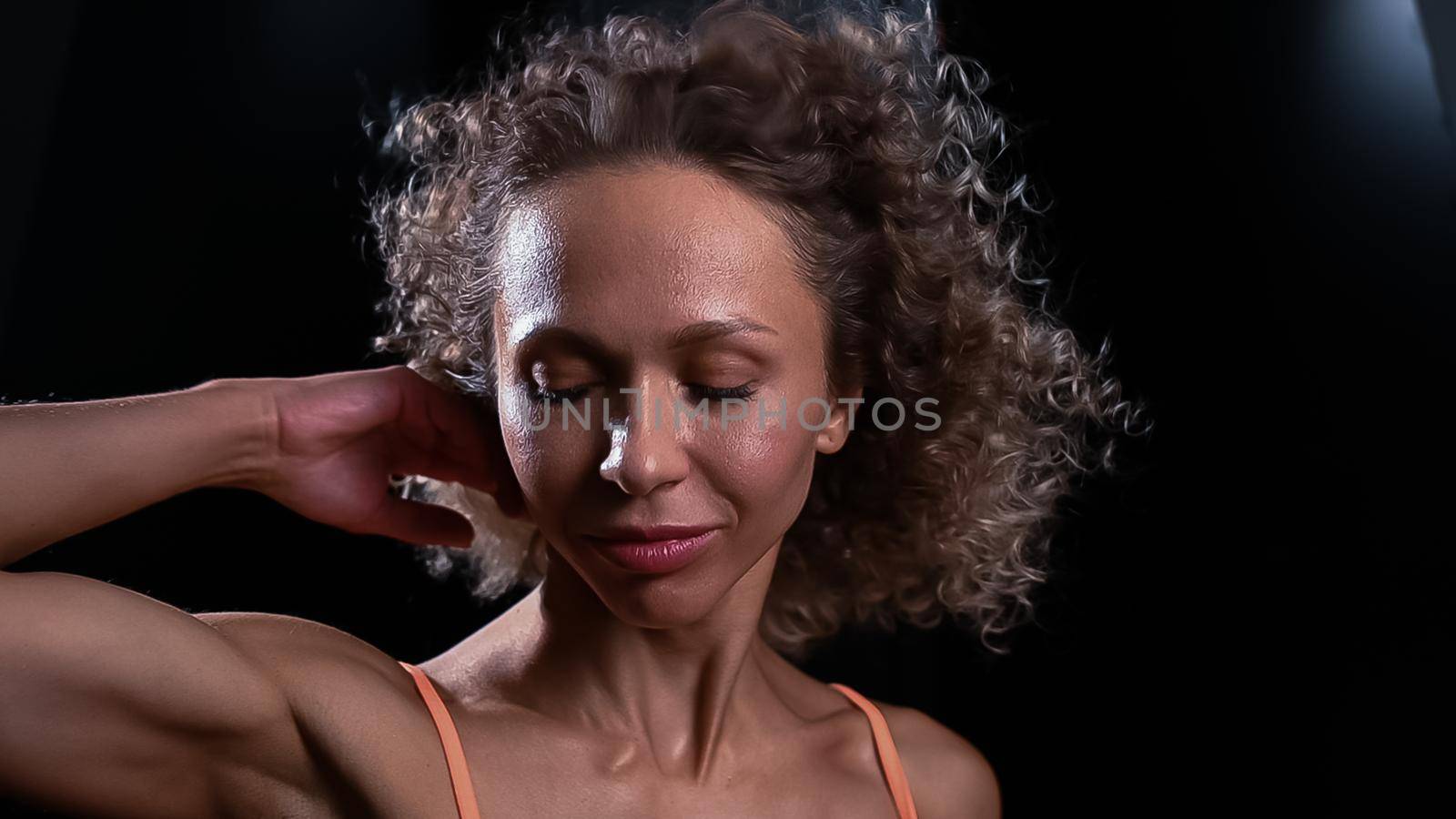 Portrait of a beautiful caucasian woman with curly hair flying in the wind.