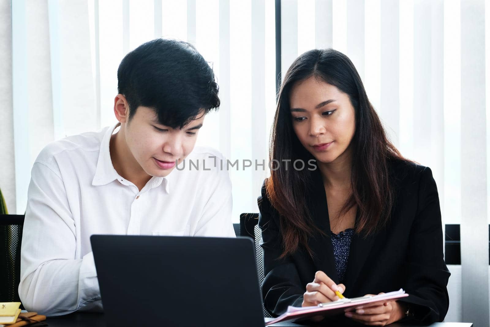 Two young business executives are discussing to change their business concept to increase profits and the strength of their business