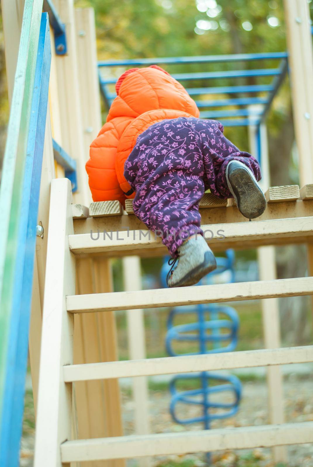 the child climbs the steps on the playground. High quality photo