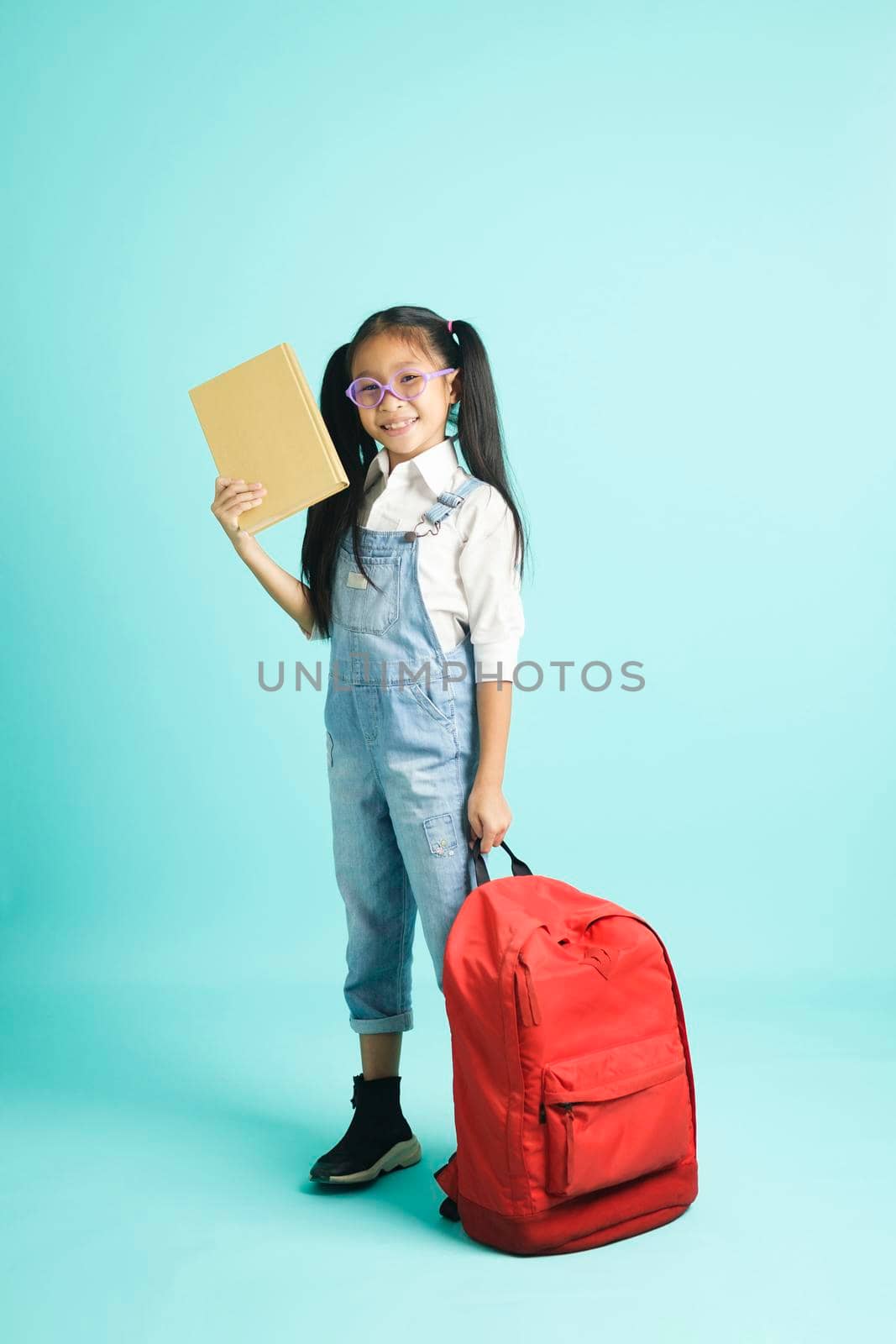kid students girl smiling holding book, going to school. by ijeab
