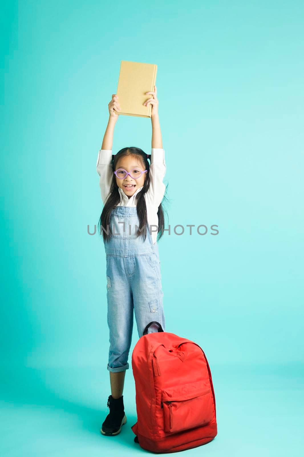 kid students girl smiling holding book, going to school. school concept.