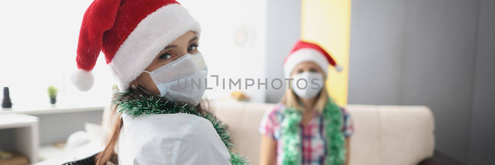 Young woman visit friend in hospital, relative in wheelchair, face mask for protection by kuprevich