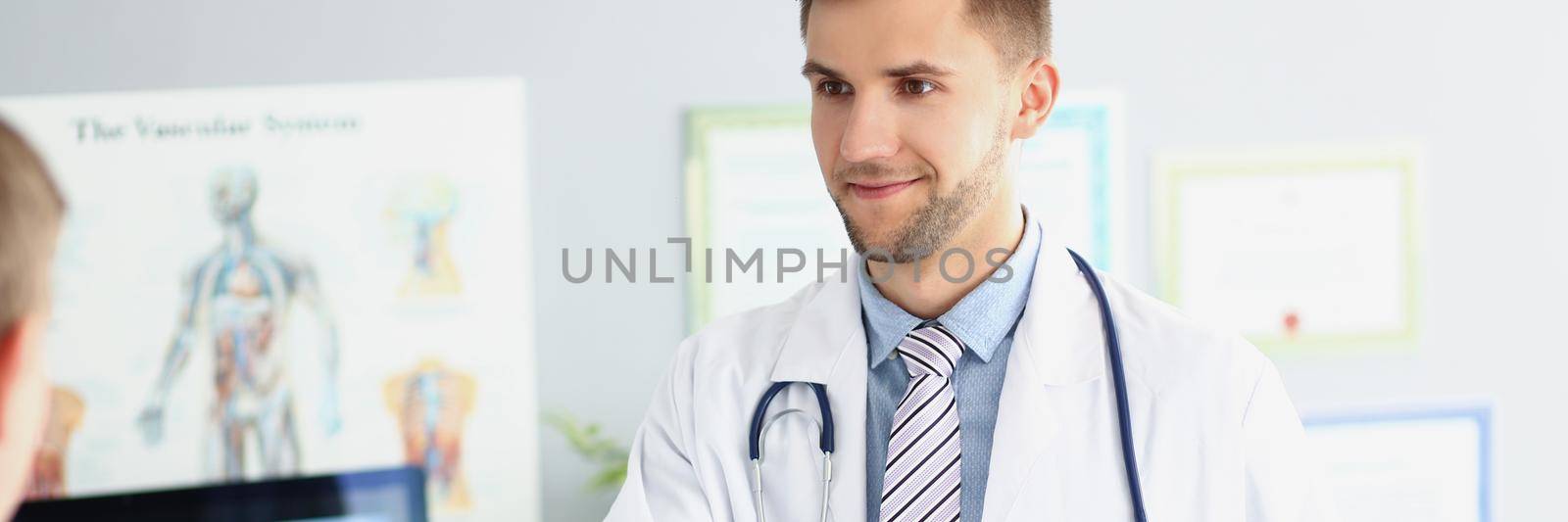 Portrait of joyful specialist greeting colleague with gladness and handshake. Intelligent doctor wear white medical uniform. Medical conference concept