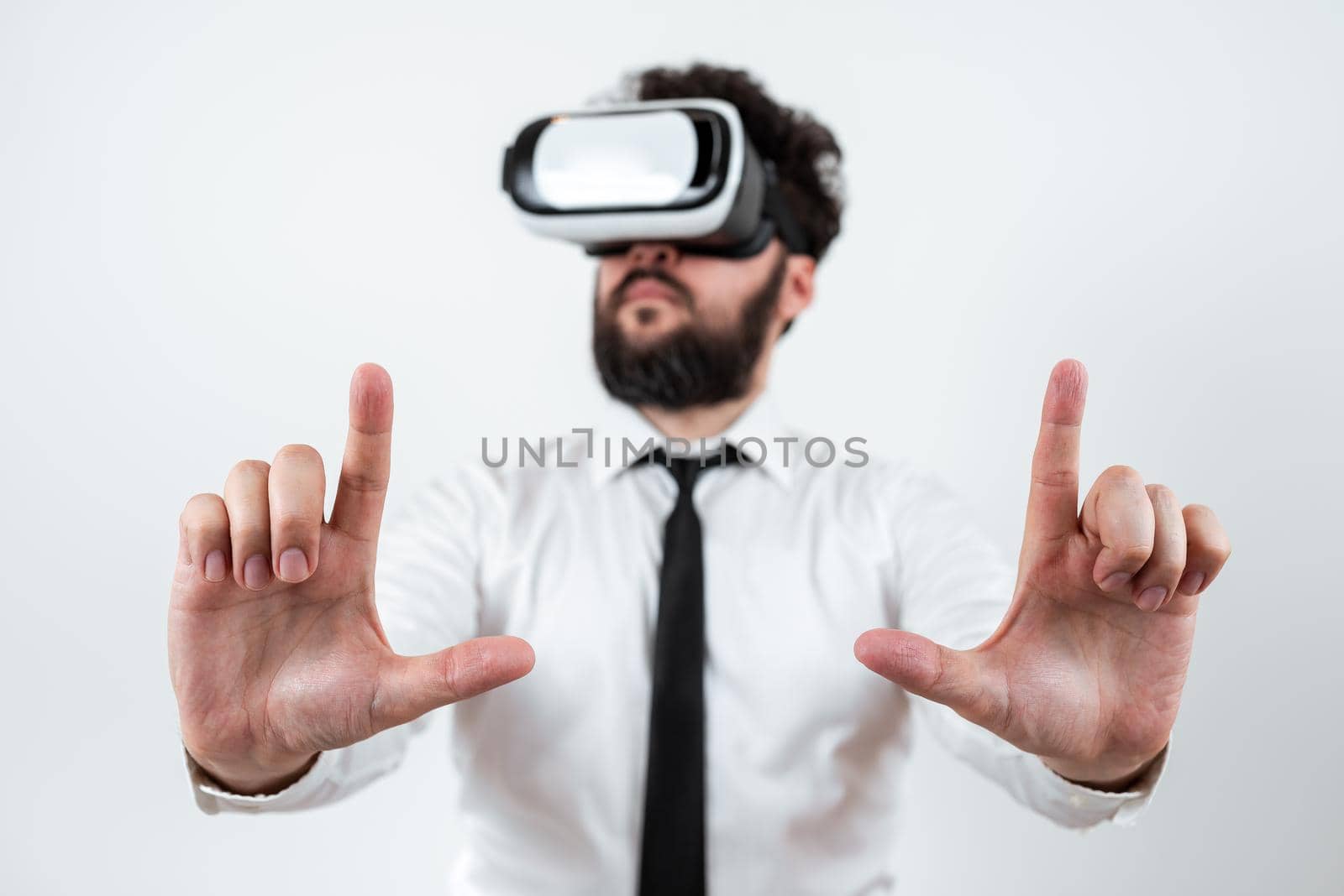 Man Wearing Vr Glasses And Presenting Important Messages Between Hands. Businessman Having Virtual Reality Eyeglasses And Showing Crutial Informations. by nialowwa