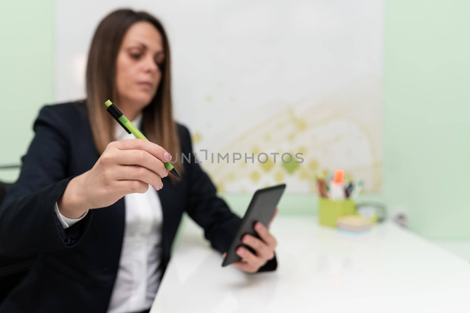 Businesswoman Having Tablet On Desk And Pointing New Ideas With Pen.