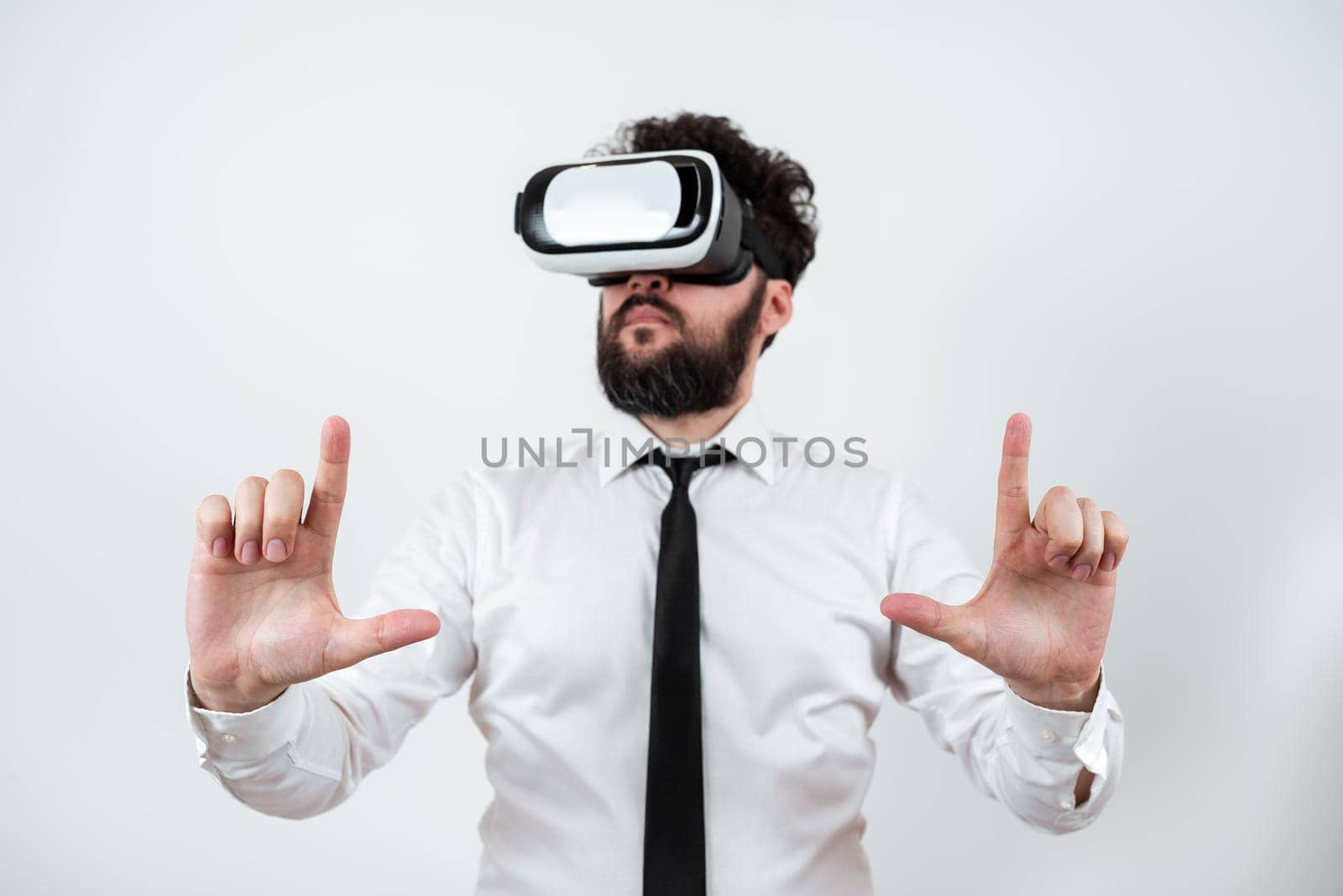 Man Wearing Vr Glasses And Presenting Important Messages Between Hands. Businessman Having Virtual Reality Eyeglasses And Showing Crutial Informations. by nialowwa