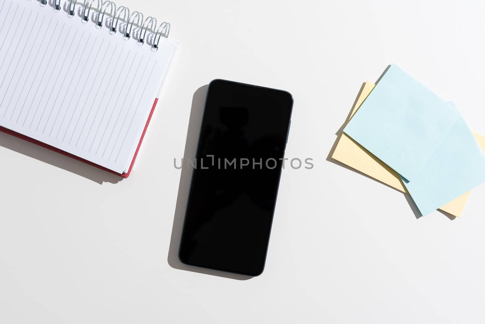 Mobile Phone With Important Message On Desk With Empty Notebook And Notes.