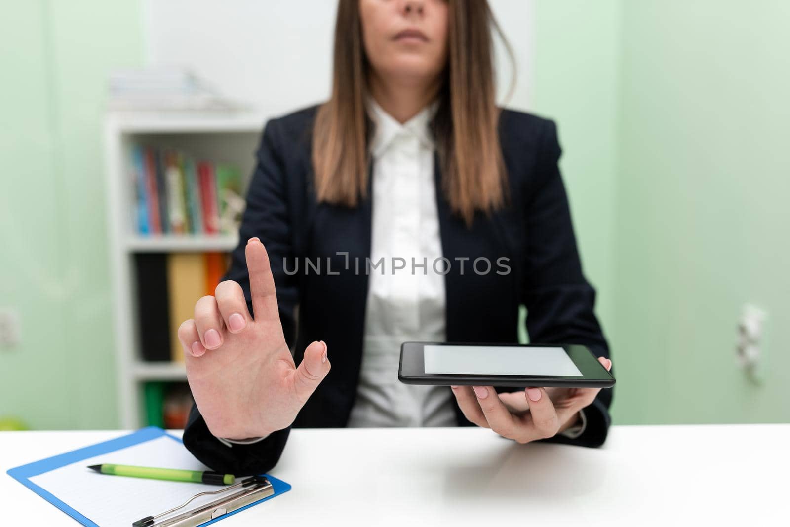 Businesswoman Holding Marker With One Hand And Pointing Important Ideas.