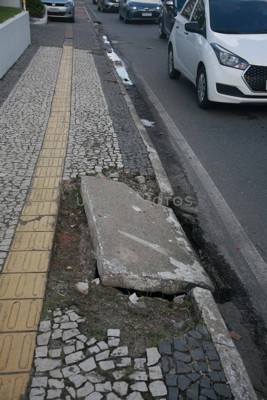 salvador, bahia, brazil - july 19, 2022: Pedestrian sidewalk with damaged floor on a street in Salvador city.