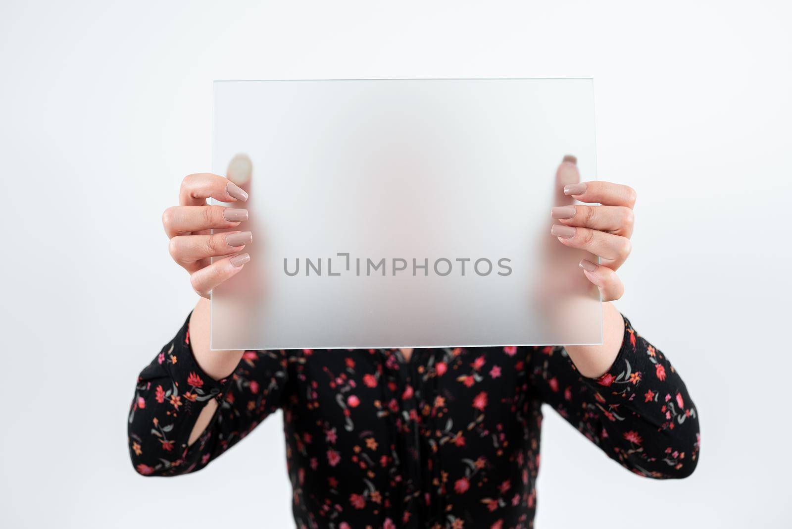 Businesswoman Holding Blank Placard And Making Important Announcement. Woman Wearing Floral T-Shirt Showing Board Presenting New Ideas For Marketing The Business. by nialowwa