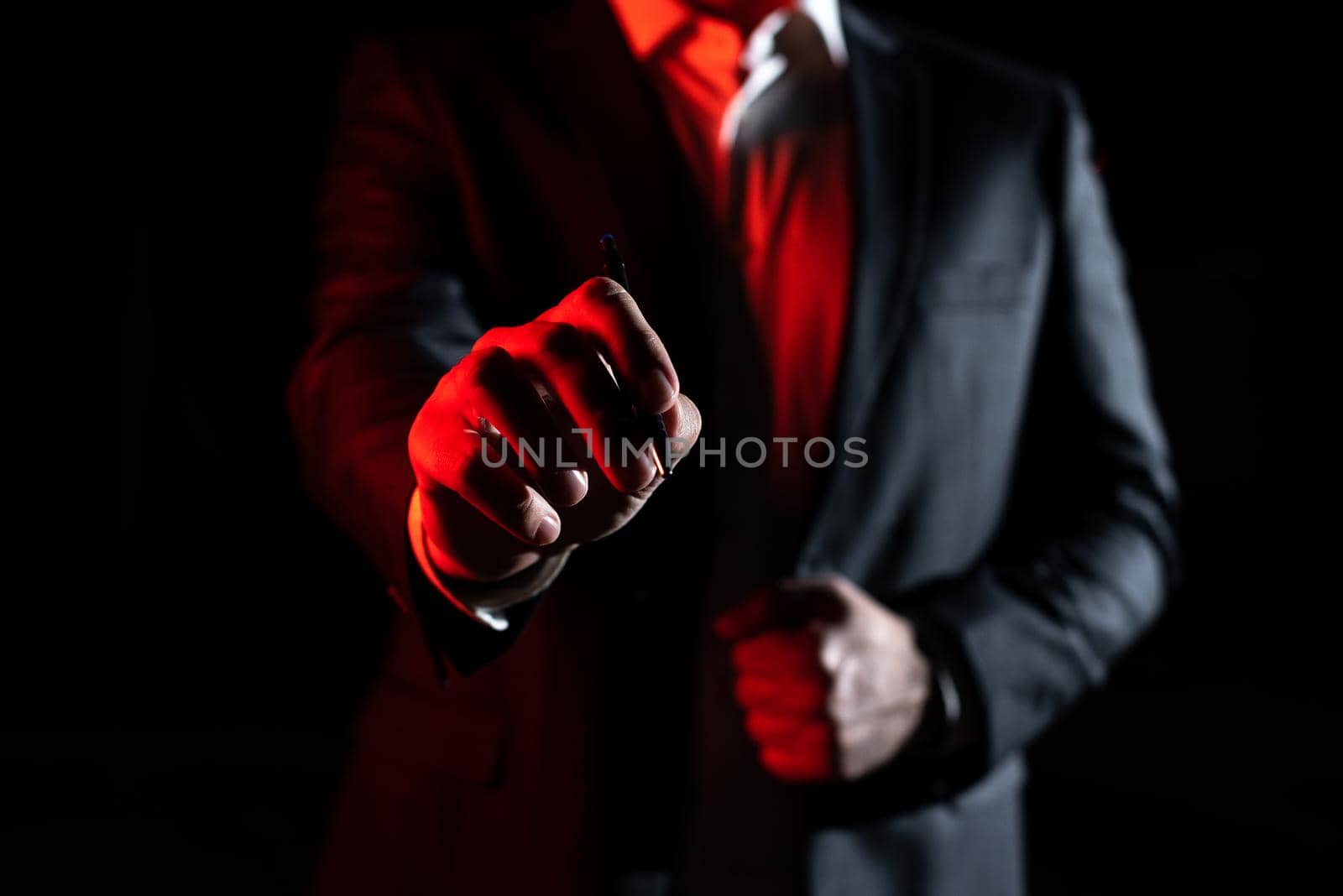 Businessman Pointing Important Informations With Pen In Hand.