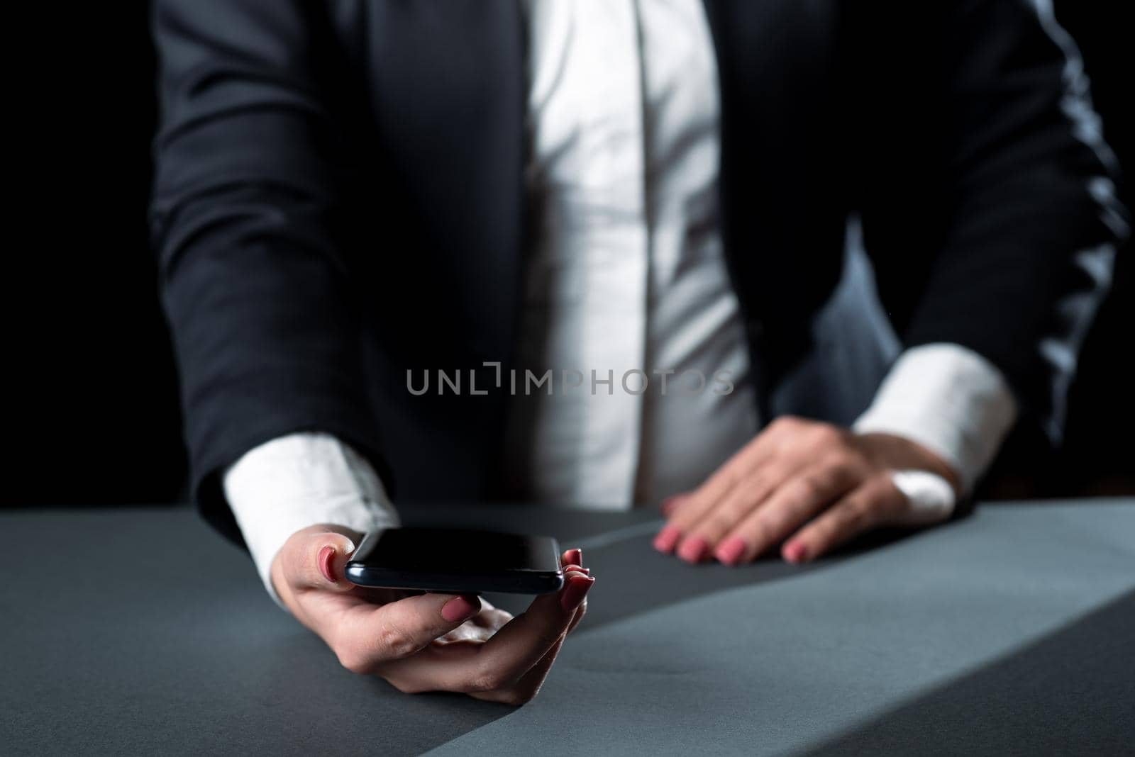 Businesswoman Holding Cellphone And Presenting Important Informations.