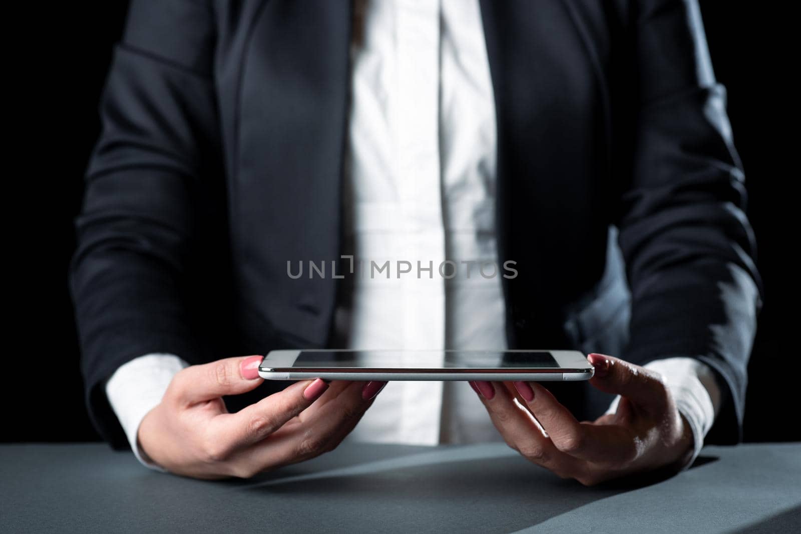 Businesswoman Holding Tablet And Presenting Important Informations. Woman Showing Recent Updates On Screen. Executive Displaying Late Achievements On Cellphone. by nialowwa