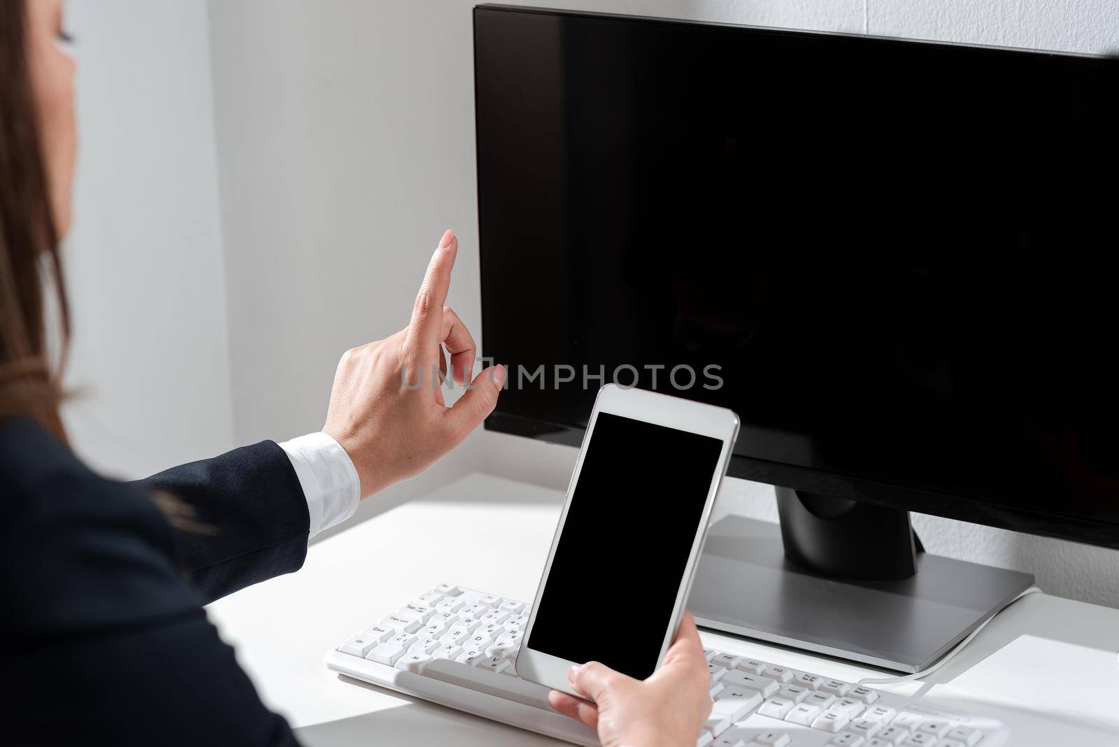 Woman Holding Mobile Phone And Pointing With One Finger On Important News.