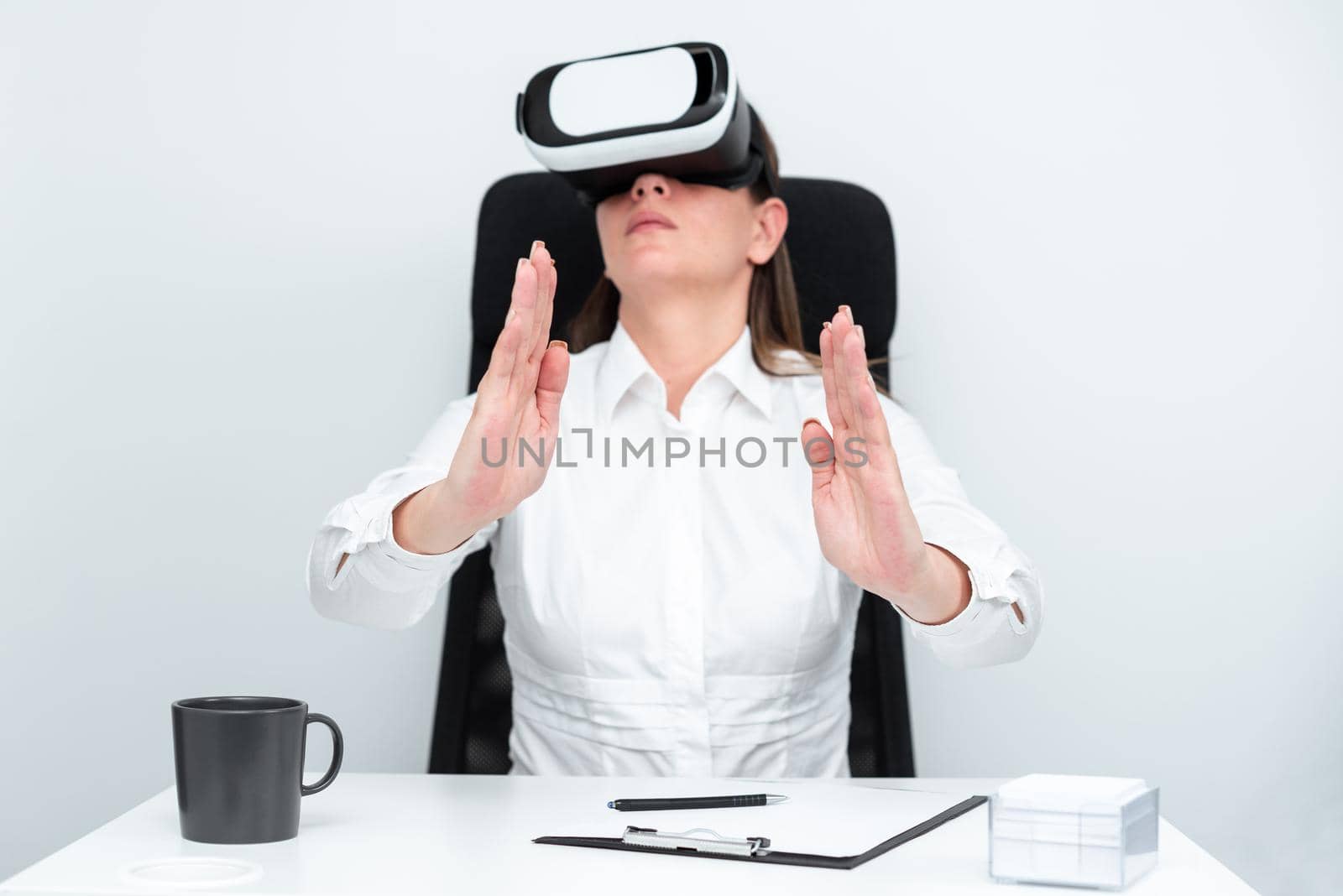 Woman Wearing Headset And Learning Skill Over Virtual Reality Simulator.