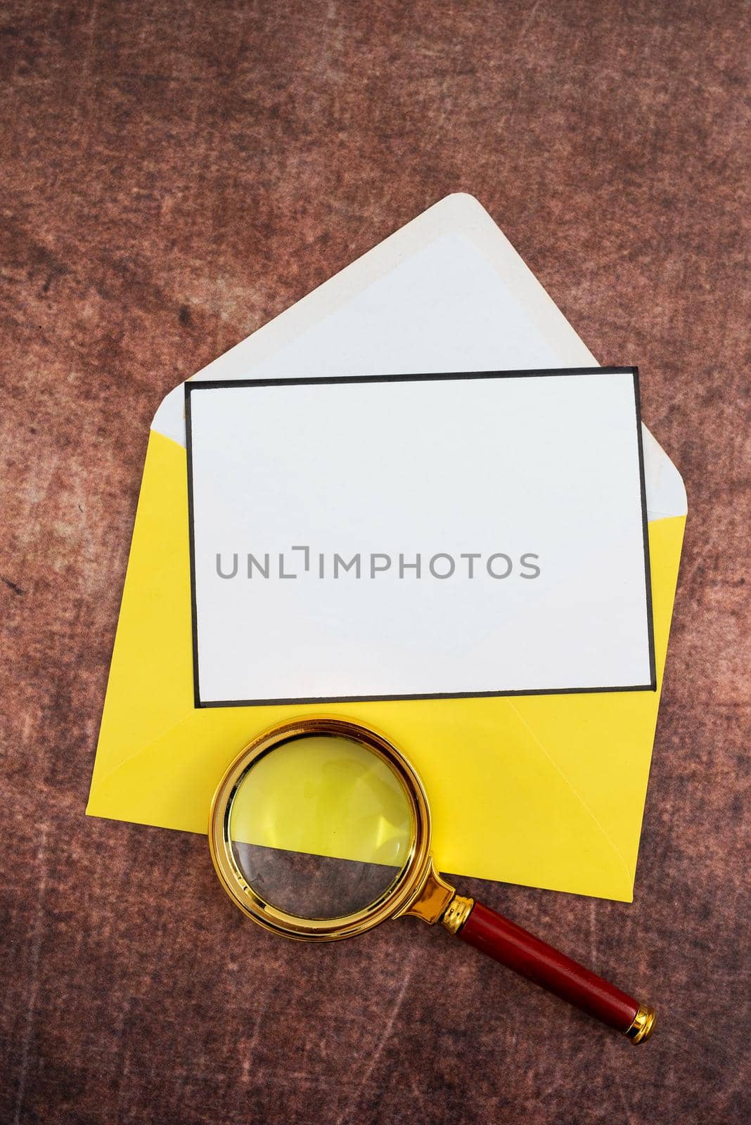 Blank Letter With Color Envelope And Magnifying Glass Placed On Wooden Table. It Is Representing Important Strategies And Crucial Message For Business Progress. by nialowwa