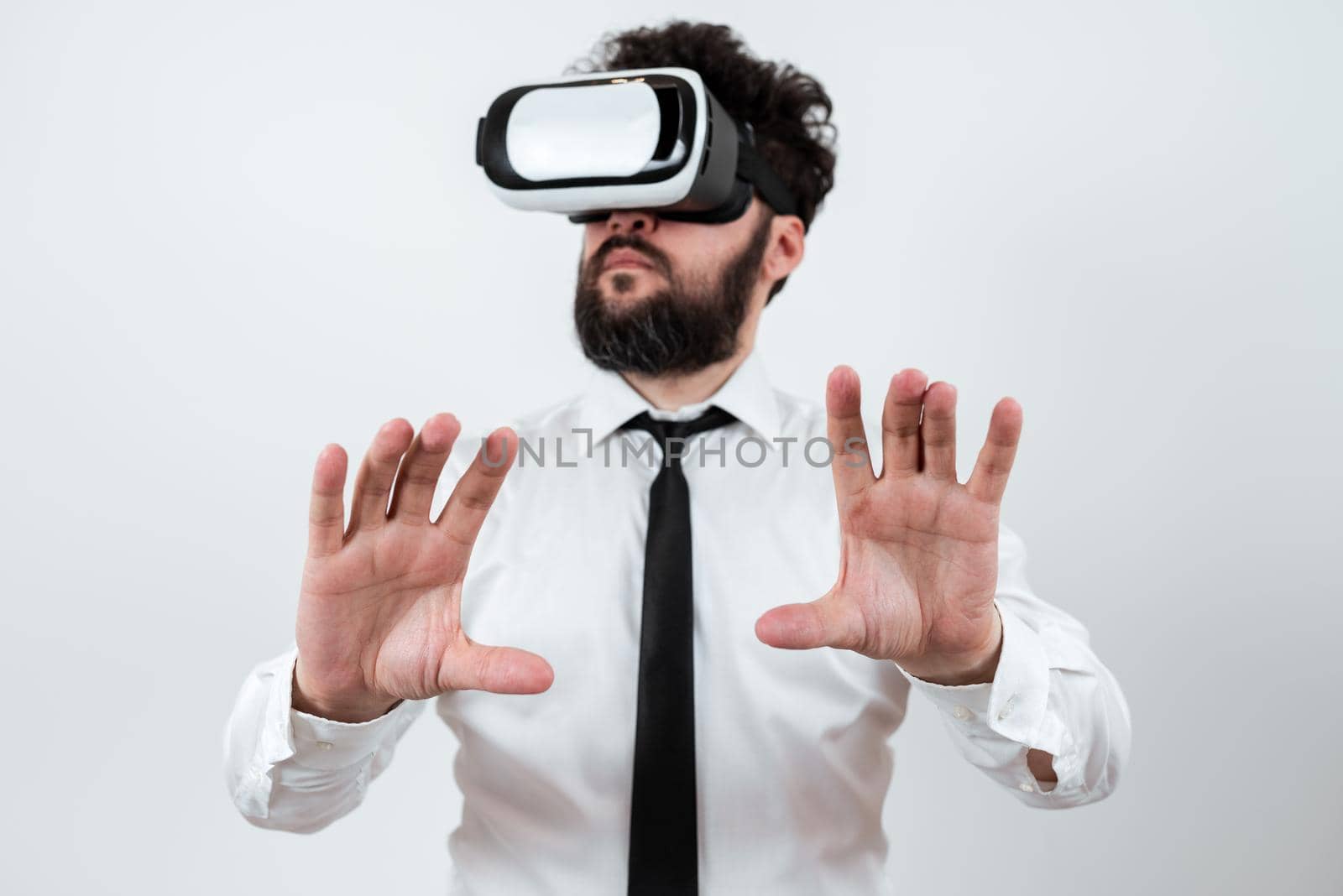 Man Wearing Vr Glasses And Presenting Important Messages Between Hands. Businessman Having Virtual Reality Eyeglasses And Showing Crutial Informations. by nialowwa