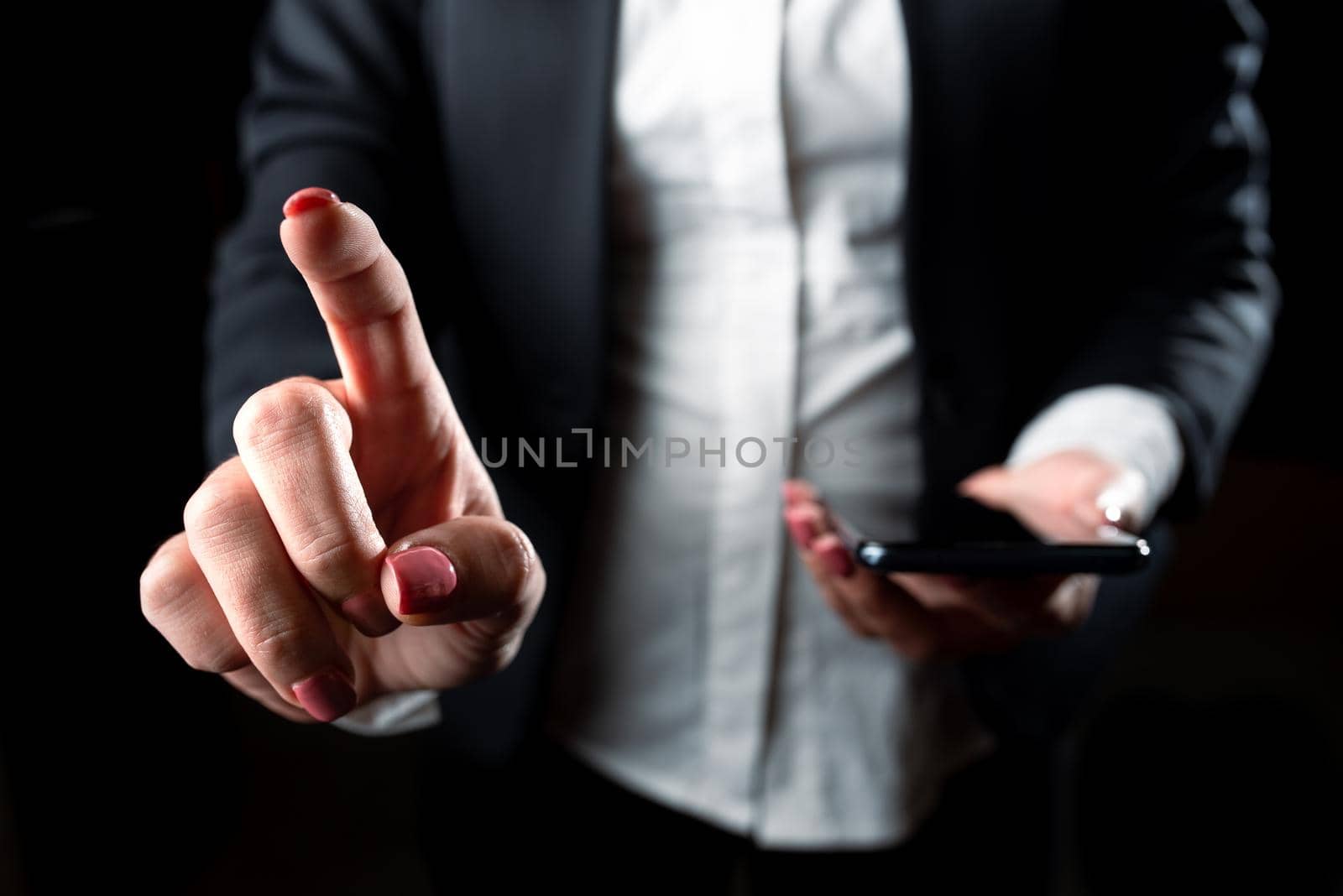 Businesswoman Holding Cellphone And Pointing New Ideas With One Finger.