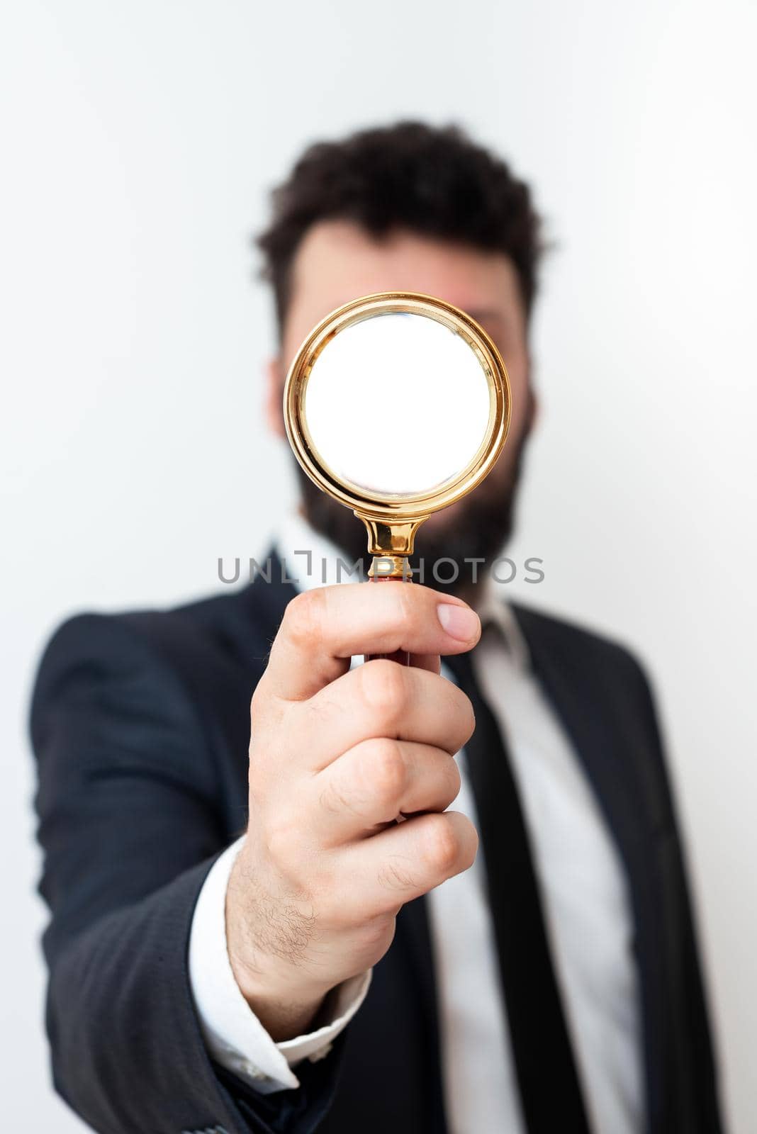 Businessman Holding Magnifier In One Hand. Man Having Magnifying Glass To Point Important Information. Gentleman Zooming Crutial Message. Executive Presenting New Idea. by nialowwa