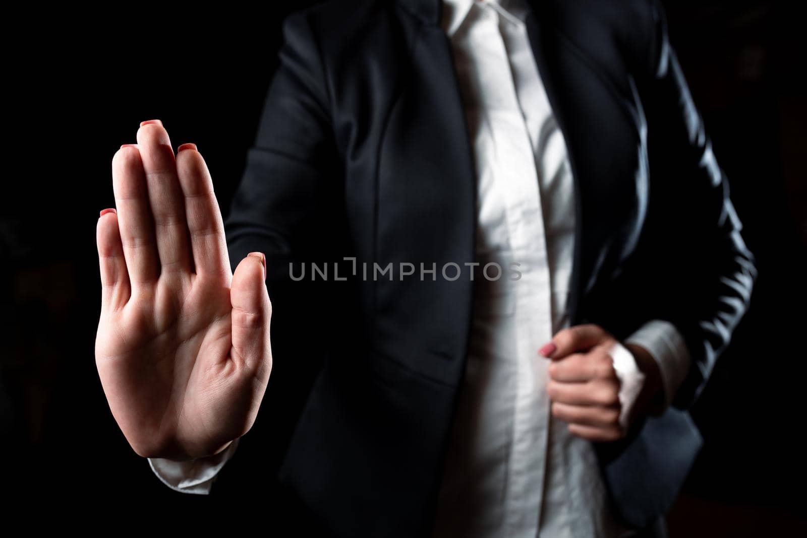 Businesswoman Showing Important Messages With One Hand. Woman Presenting Critical Announcements With Palm. Executive Displaying Crutial Informations. by nialowwa