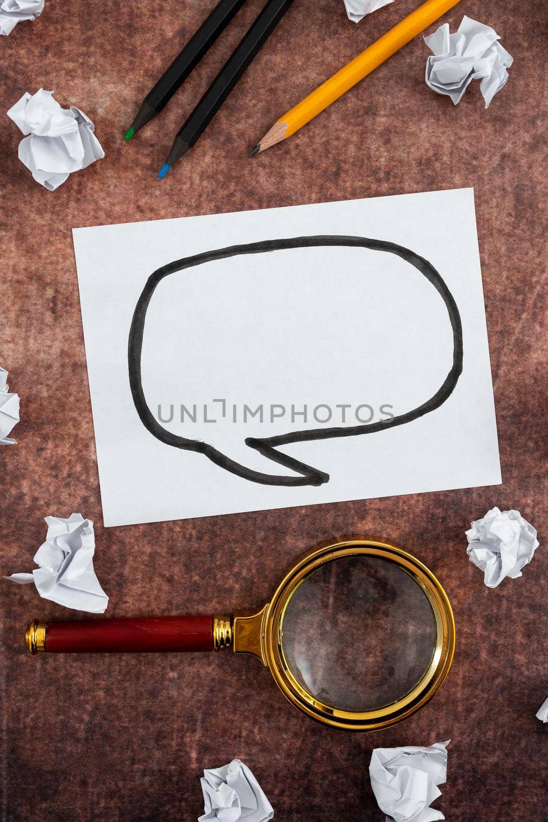 Paper With Speech Bubble Drawing, Magnifying Glass And Pencil Surrounded With Crumpled Papers Over Wood. It Is Representing Planning And Brainstorming New Ideas For Business. by nialowwa